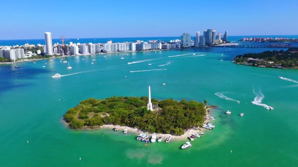 Aerial view of Flagler Memorial Island, turquoise Biscayne Bay, and the Miami skyline